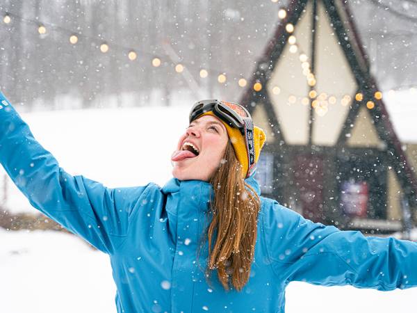 girl catching snowflakes outside
