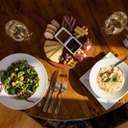 Spread of food at Stein Eriksen's showing a cheese board, salad, and chowder.