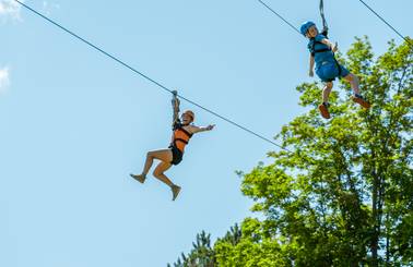 two people riding zipline
