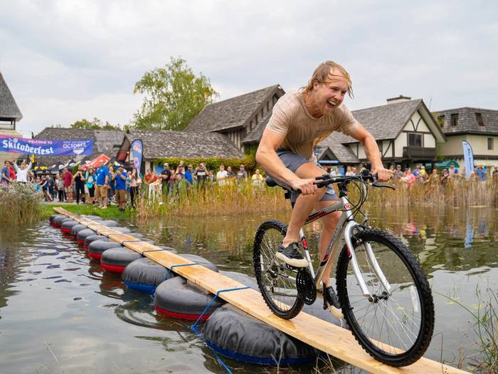 Person riding bike across pond