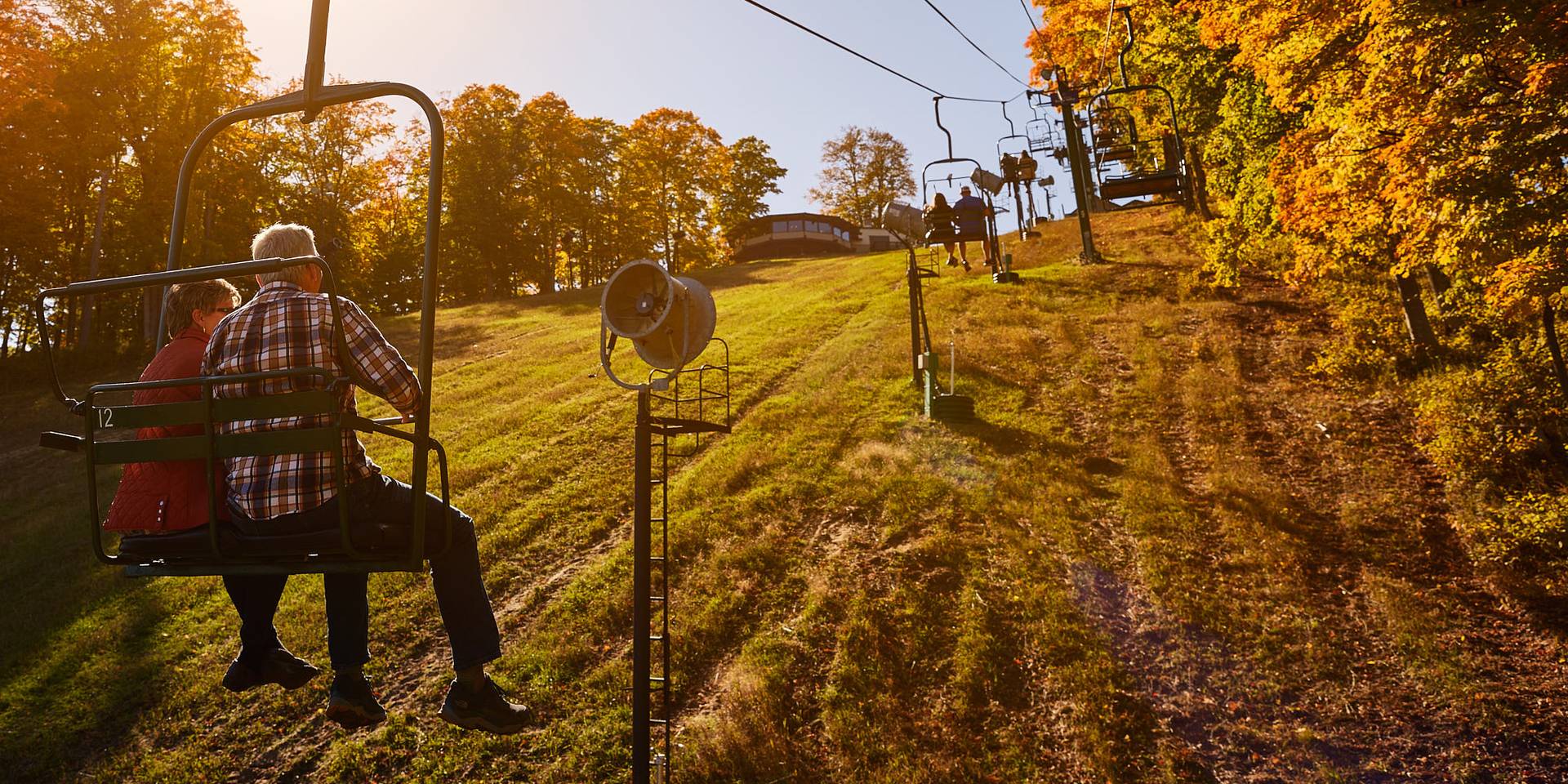 two people riding up the hemlock chairlift