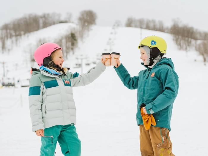 kids cheers hot cocoa at Boyne Mountain