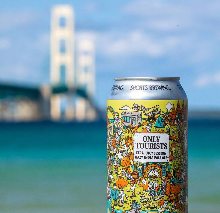 Can of Short's Brewing Company Beer in front of the Mackinac Bridge