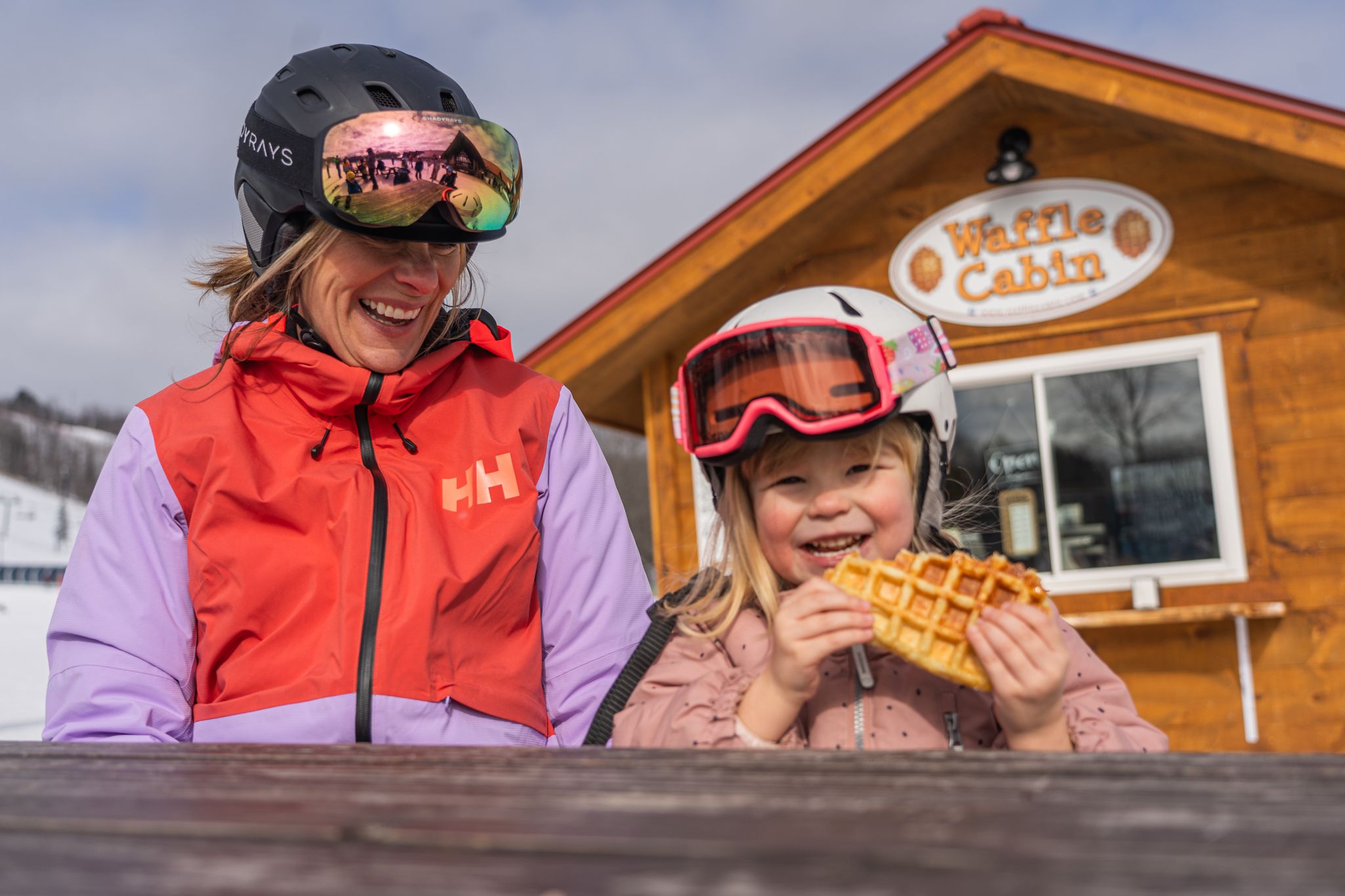 Young girl with mom eatting waffle