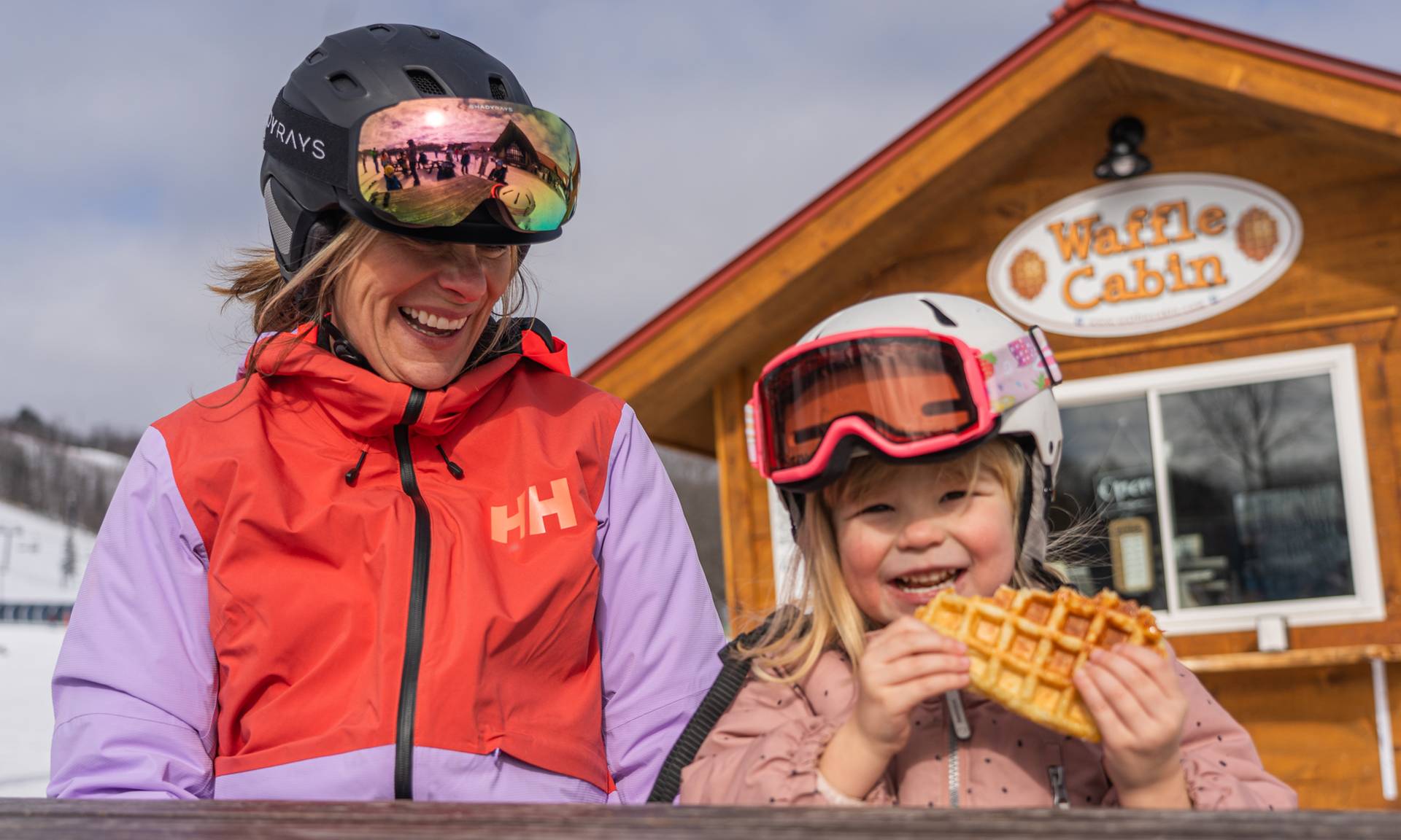 Young girl with mom eatting waffle