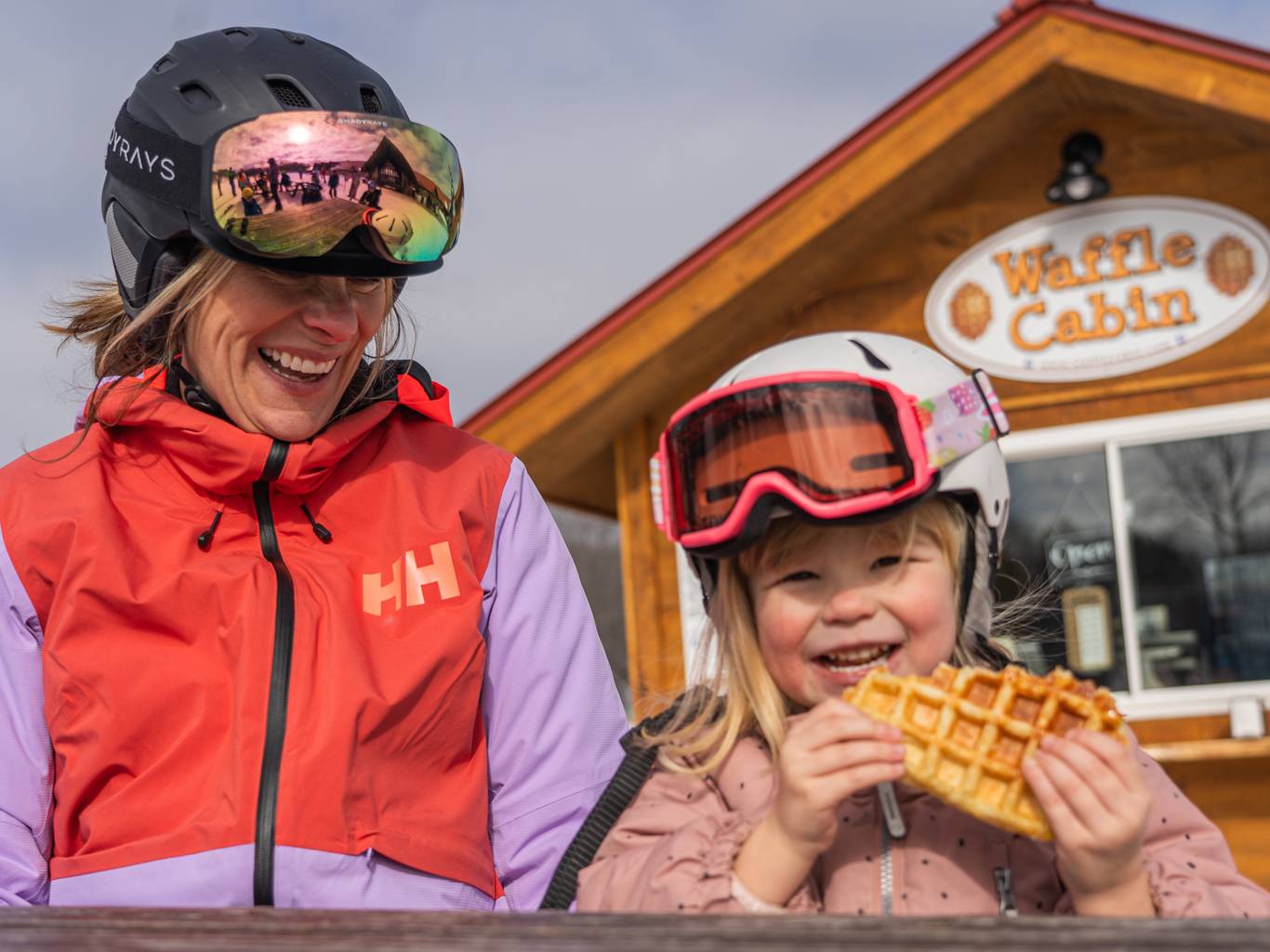Young girl with mom eatting waffle