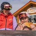 Mom and young daughter eating waffle from Waffle Cabin