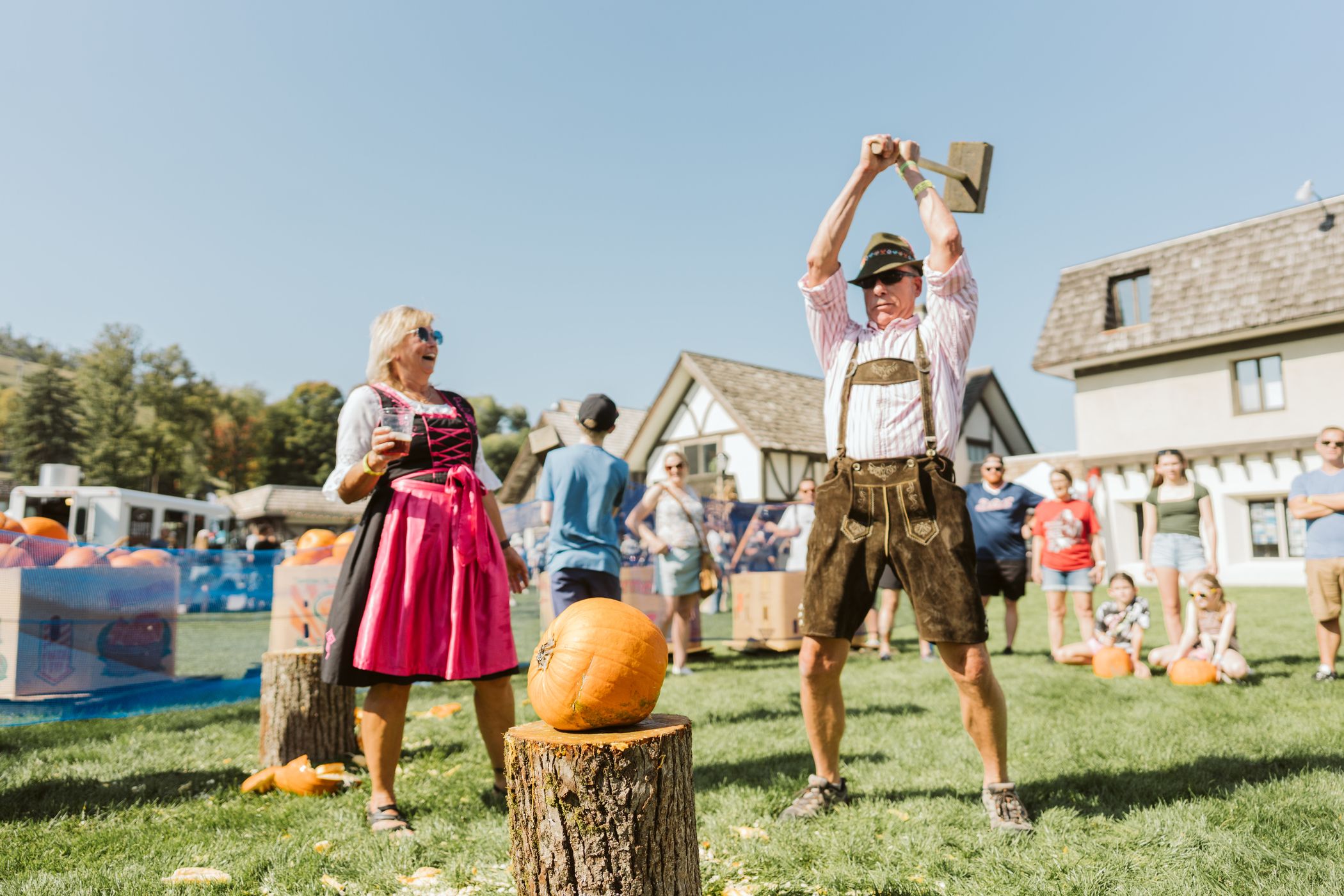 guy in lederhosen pumpkin smashing