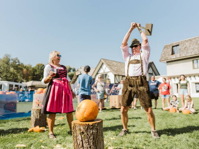 guy in lederhosen pumpkin smashing