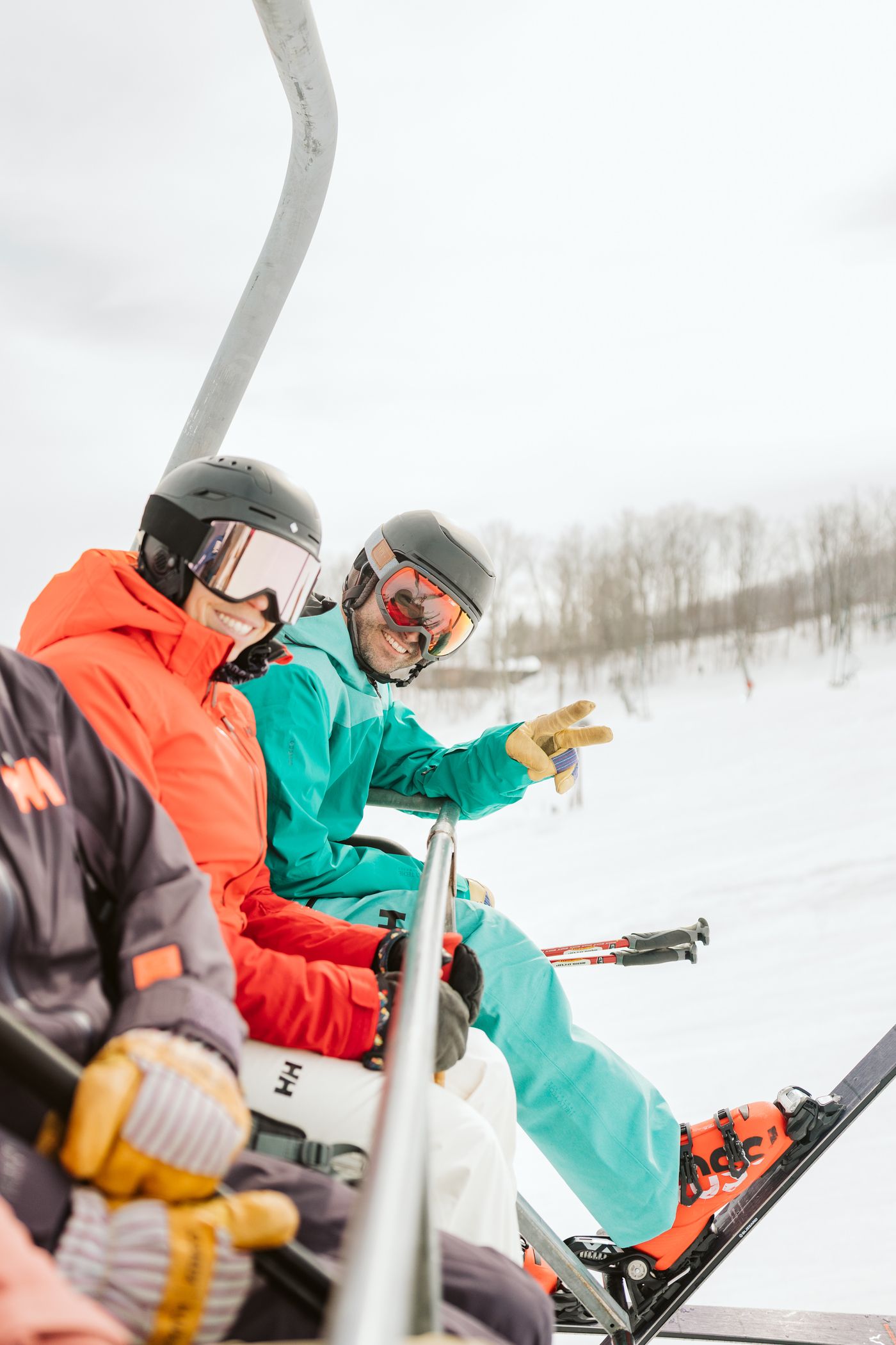 two skiers riding chairlift