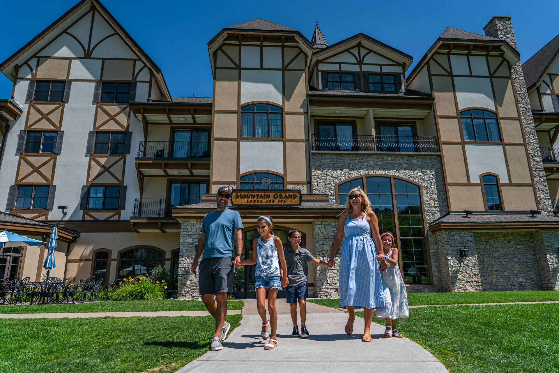 family walking out of mountain grand lodge