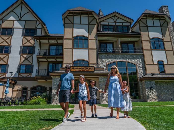 family walking out of Mountain Grand Lodge and Spa at Boyne Mountain