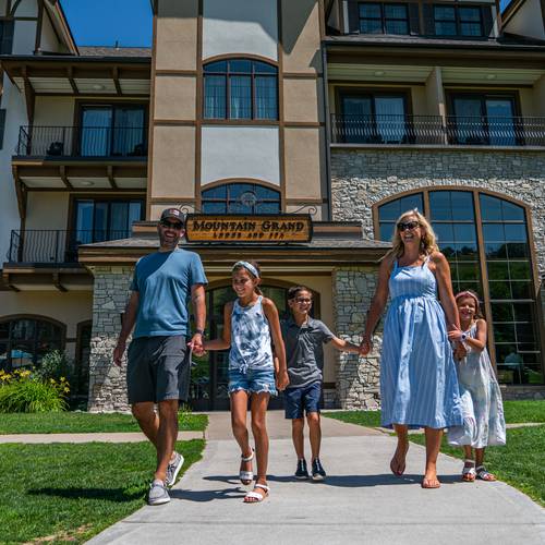 Family walking out of Mountain Grand Lodge and Spa