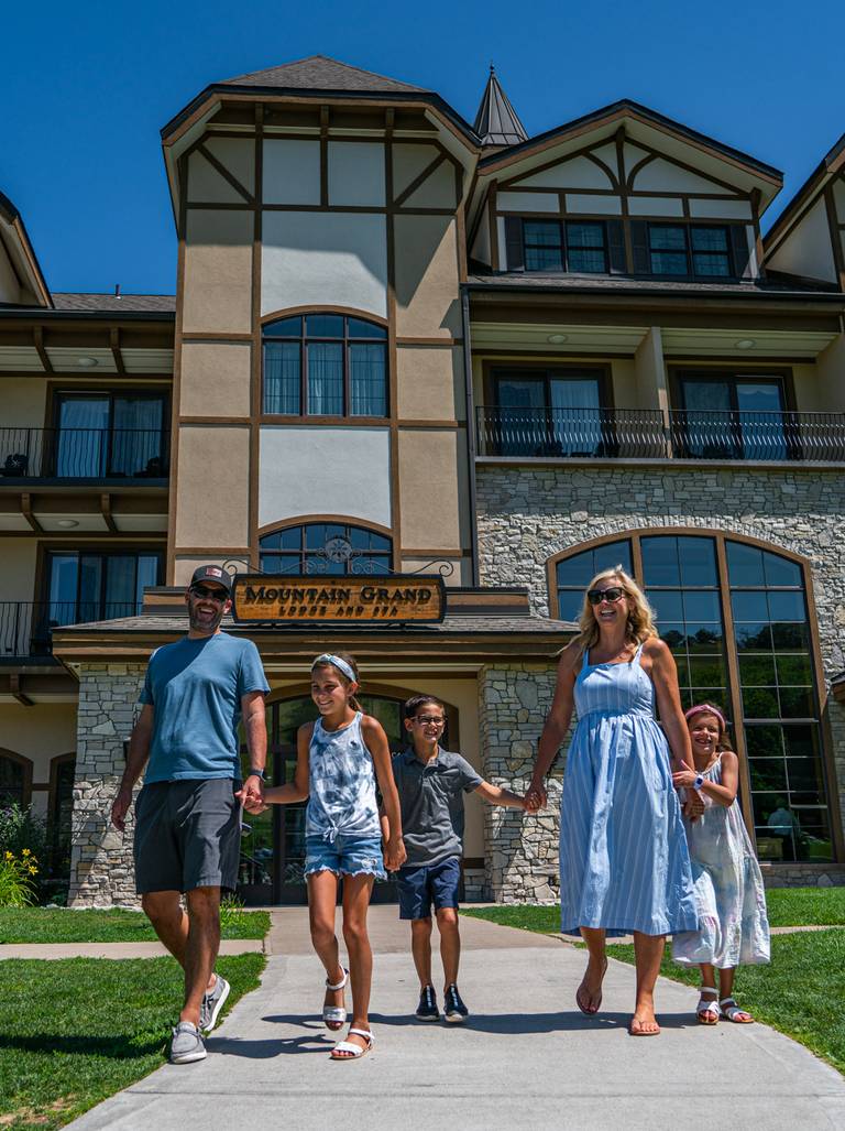Family walking outside the Mountain Grand Lodge and Spa