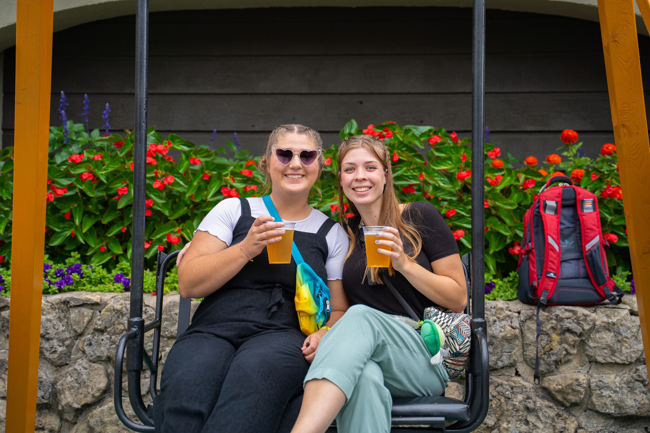 Two friends on a chairlift swing