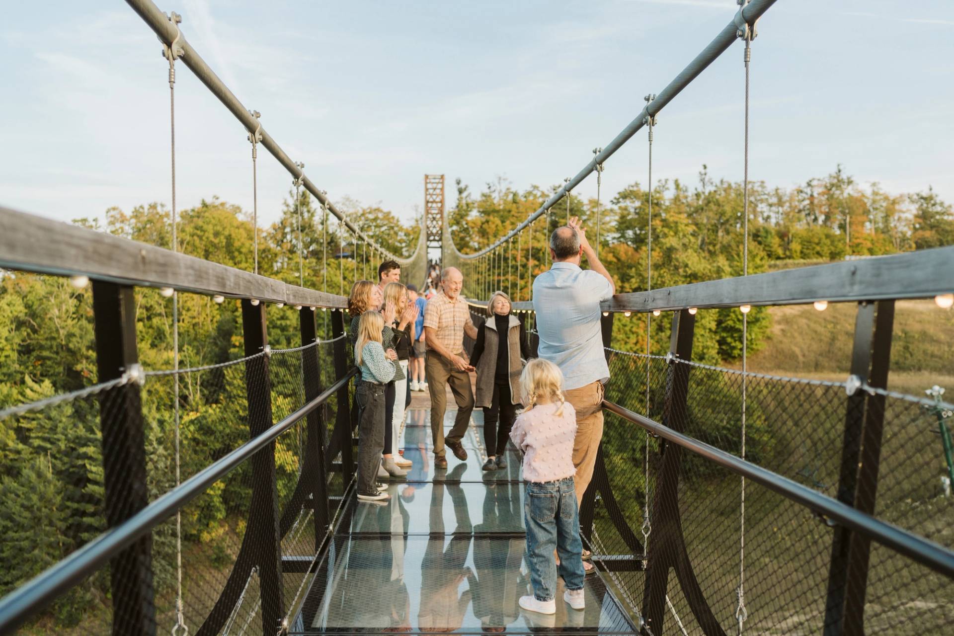 people walking on skybridge glass sections