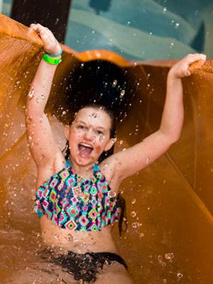 Girl at bottom of slide at waterpark
