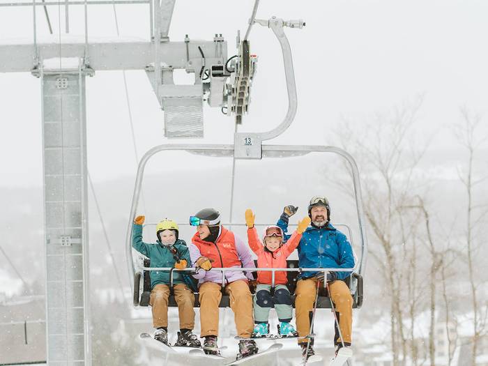 family of skiers on chairlift