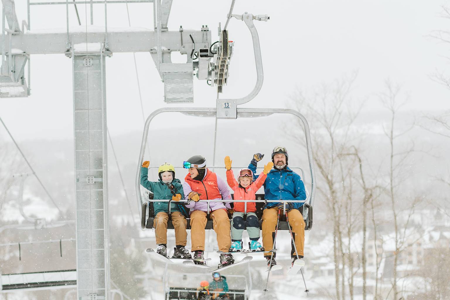 family riding chairlift in the winter
