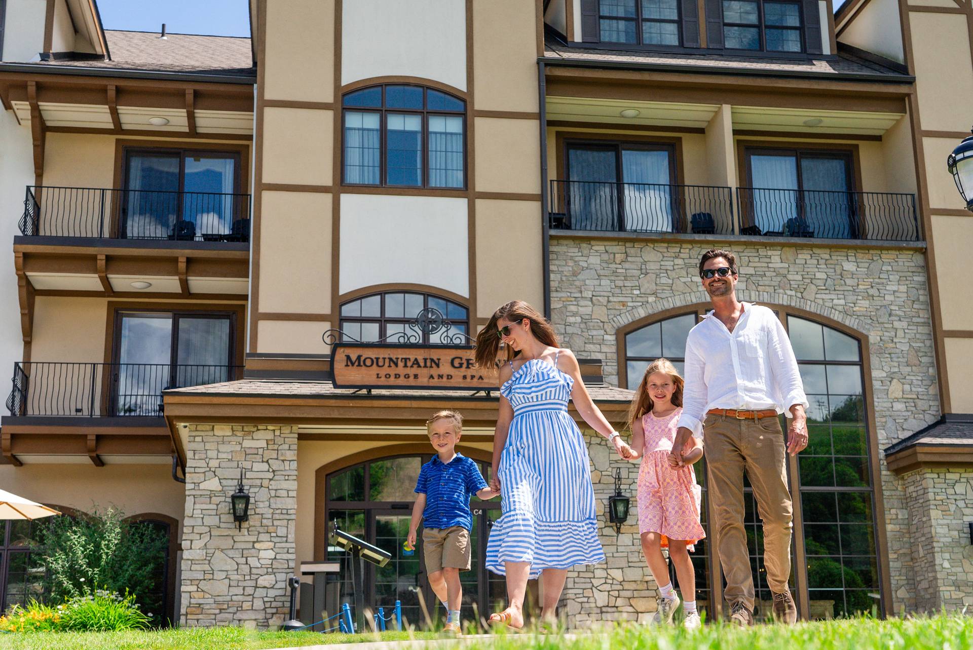family walking out of Montain Grand Lodge and Spa