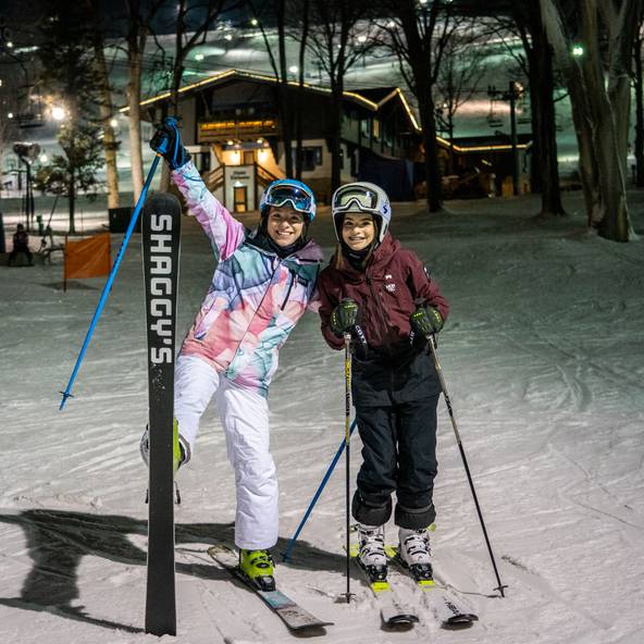 sisters skiing at night