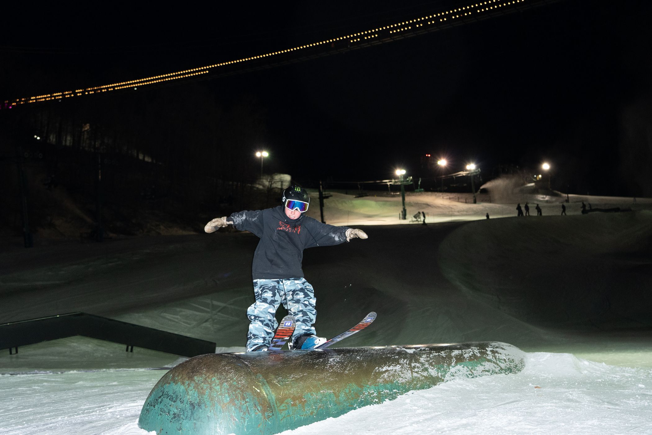 young skier hitting tube feature