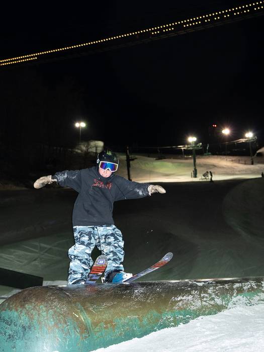 young skier hitting tube feature