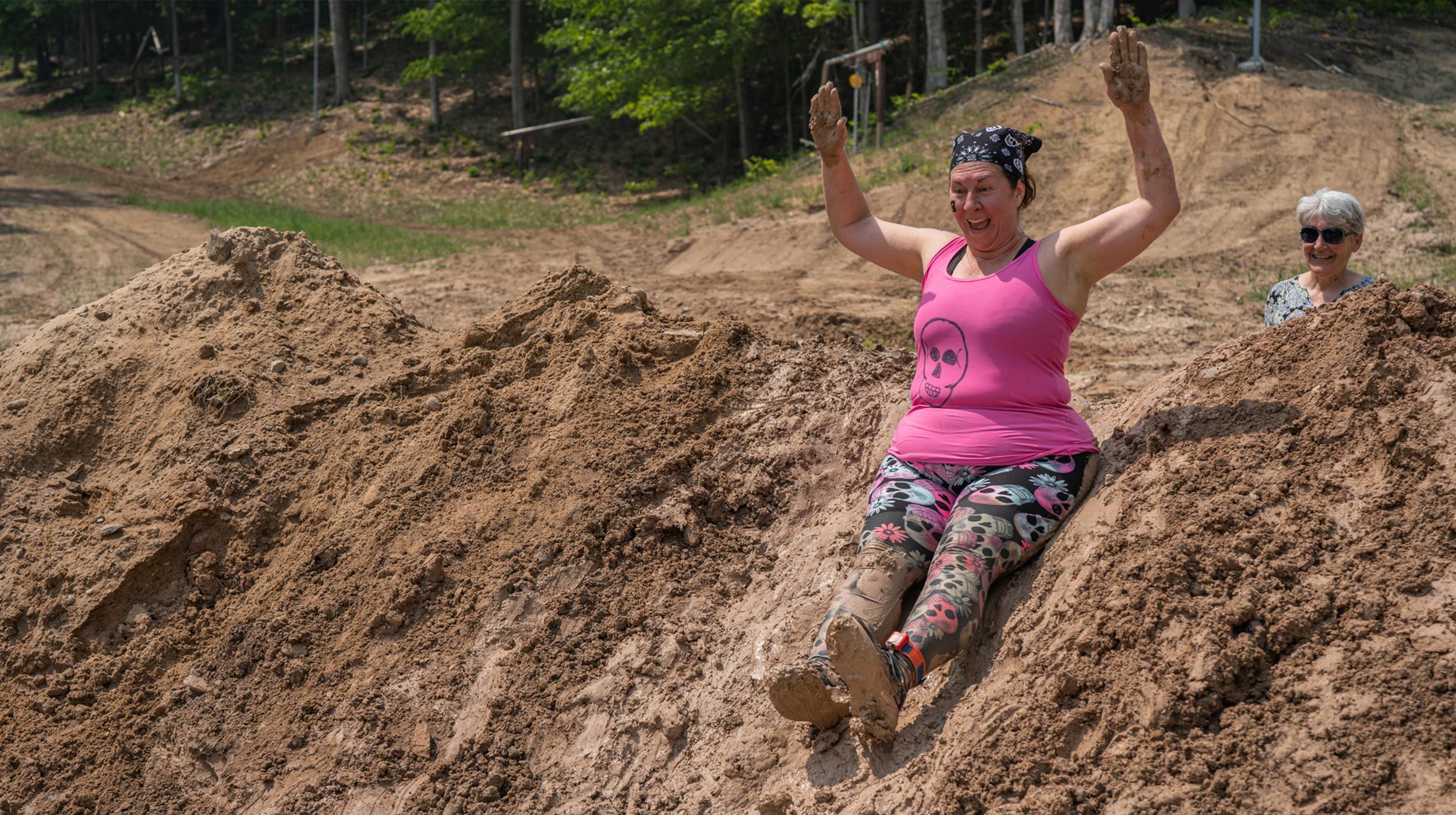 Lady sliding down a hill at Dirty Dog Dash