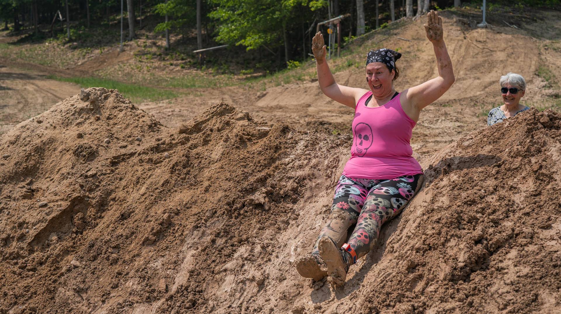 Lady sliding down a hill at Dirty Dog Dash