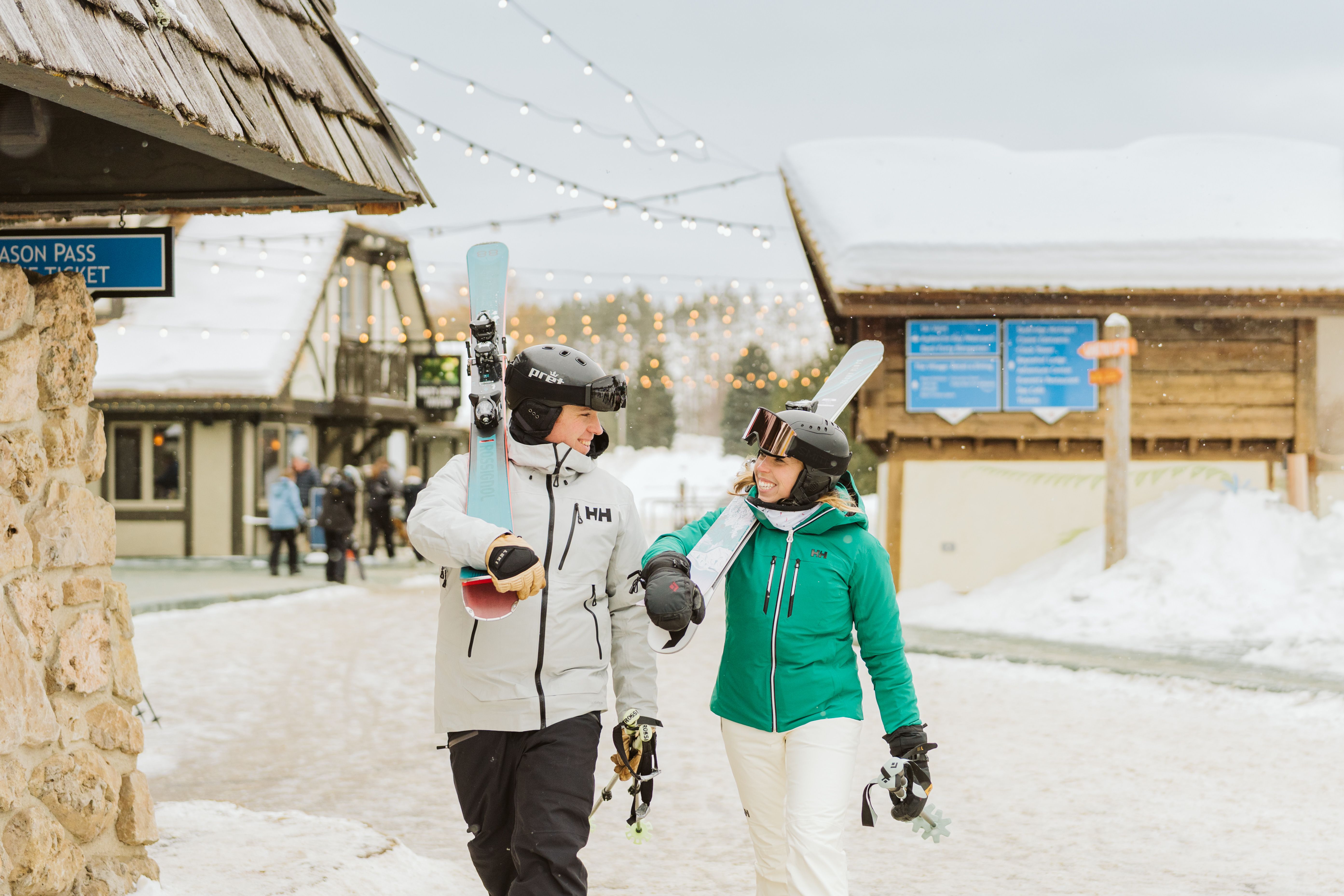 skiers holding gear smiling