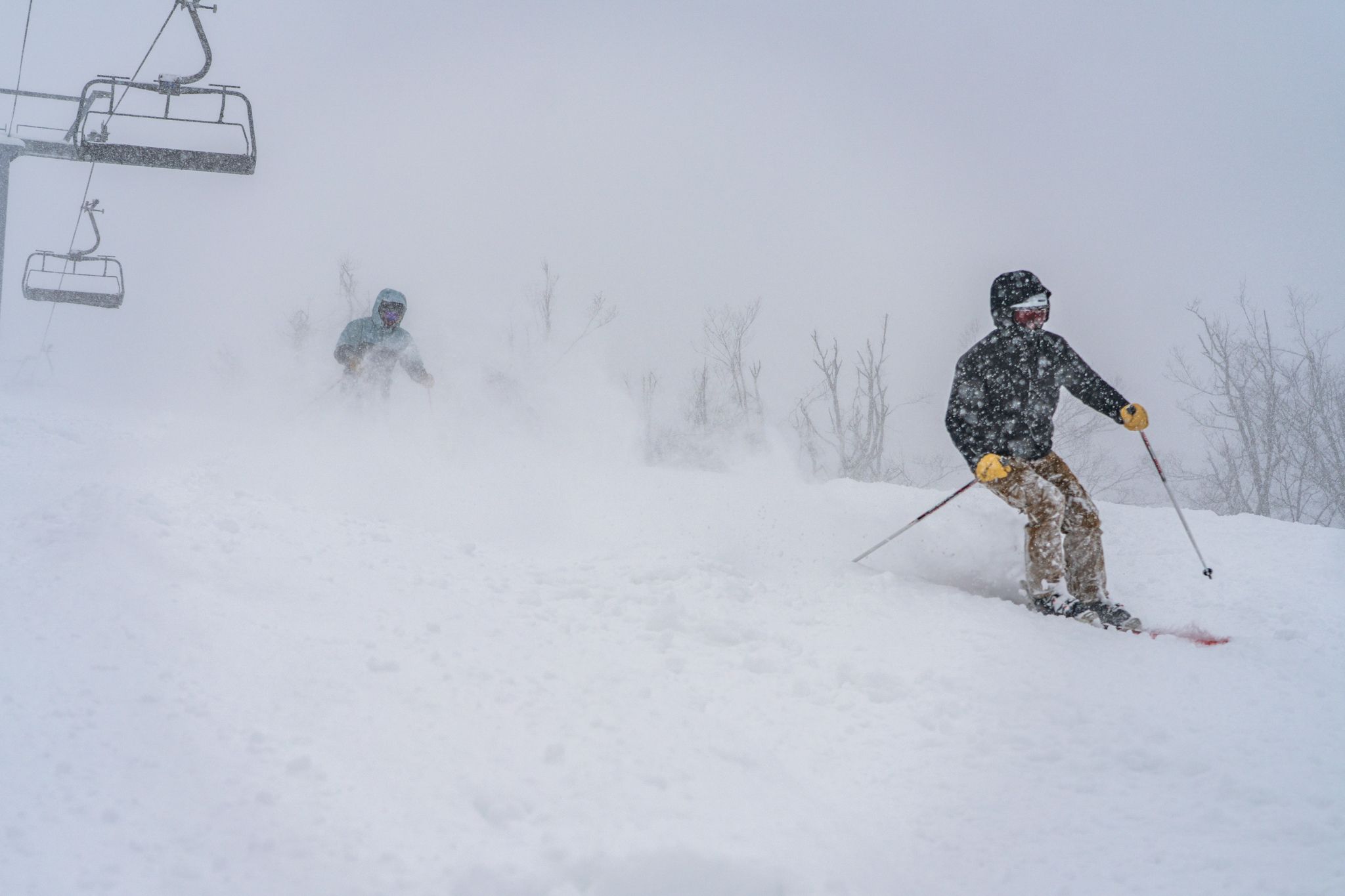 skiers riding mclouth on a powder day