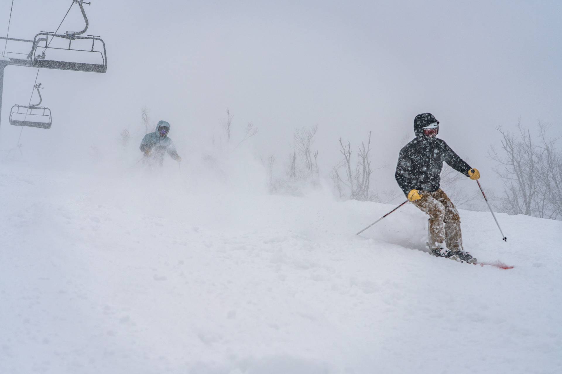 skiers riding mclouth on a powder day