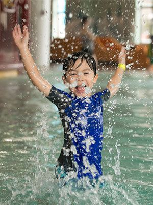 Boy splahing at Avalanche Bay Indoor Waterpark