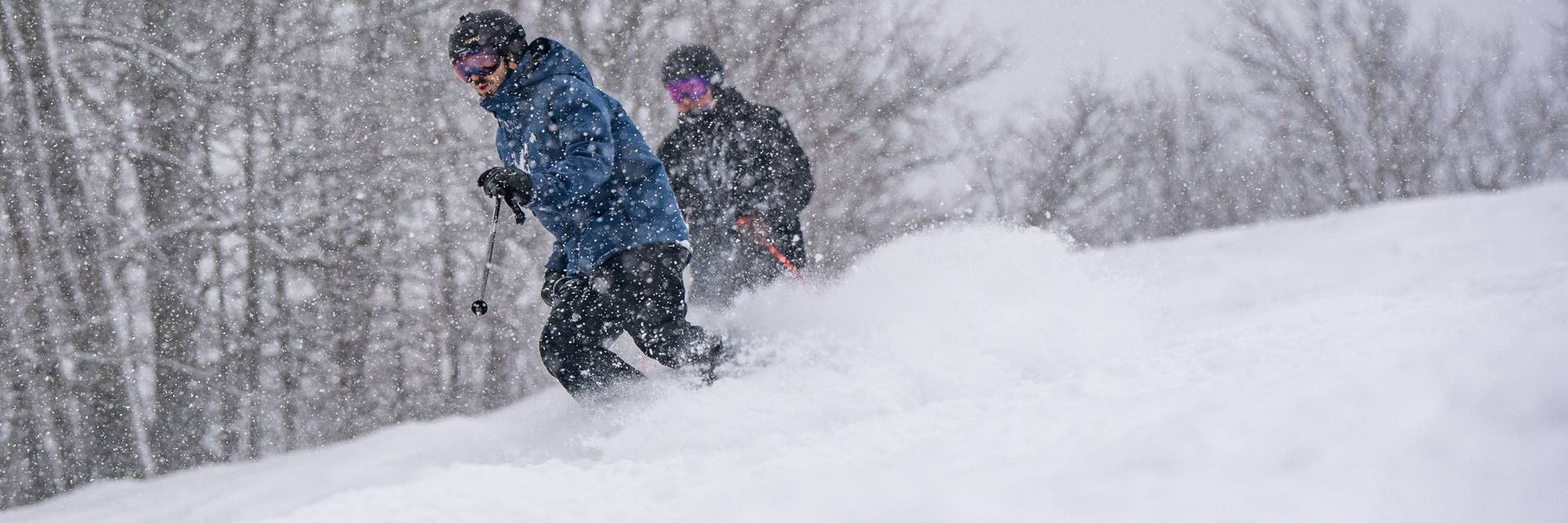 skiers riding in a snow storm