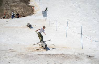 skier on rail in late season