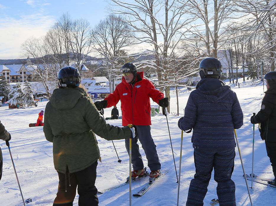 Adult group leason given by snowsports school instructor