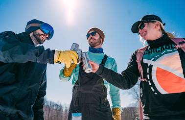 Three guys giving cheers to each other