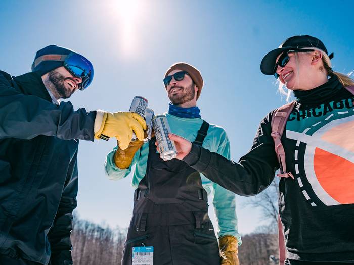 Friends toasting at the base of the hill