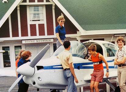 Family hanging around an airplane at Boyne Mountain.