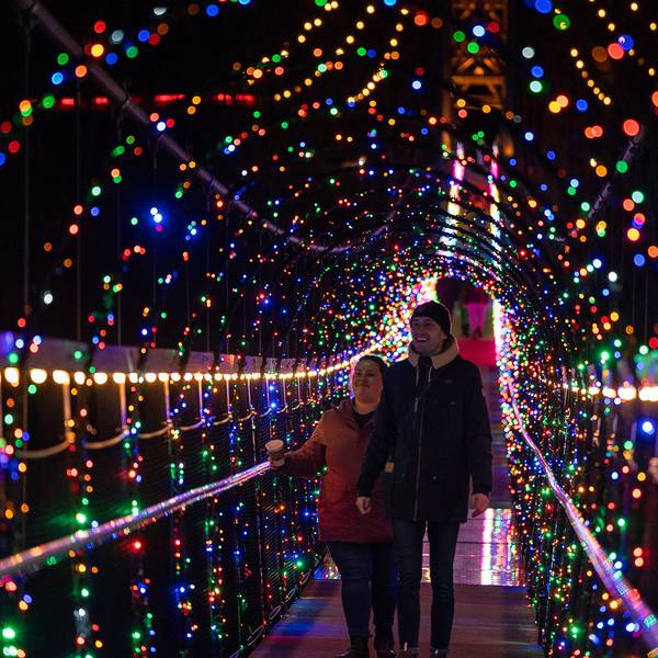 Couple walking SkyBridge Michigan during Lights in the Sky