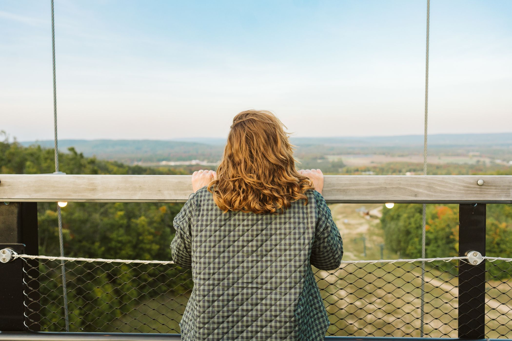 Woman looking over railing on SkyBridge Michigan