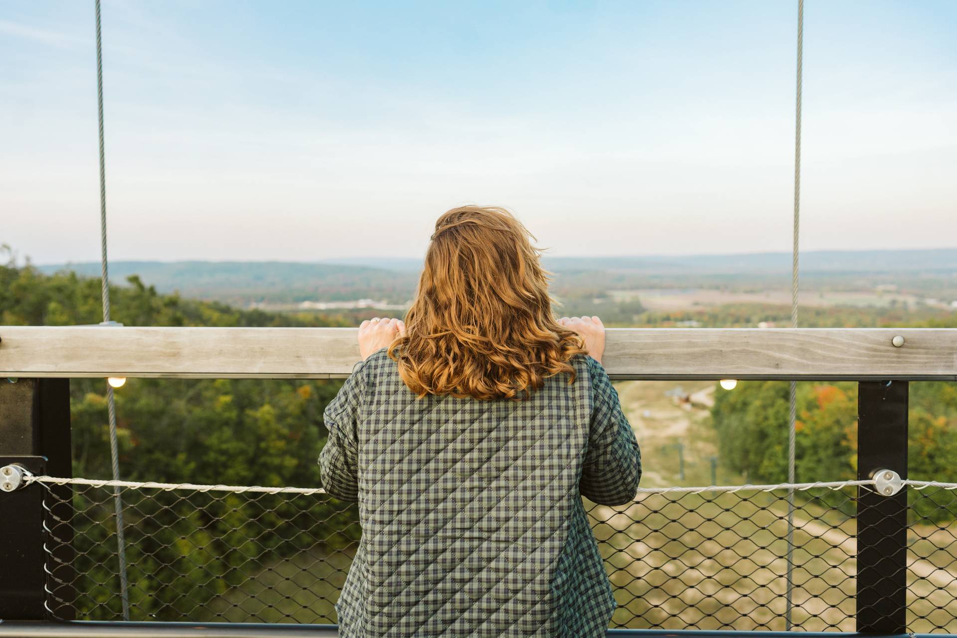 Woman looking over railing on SkyBridge Michigan