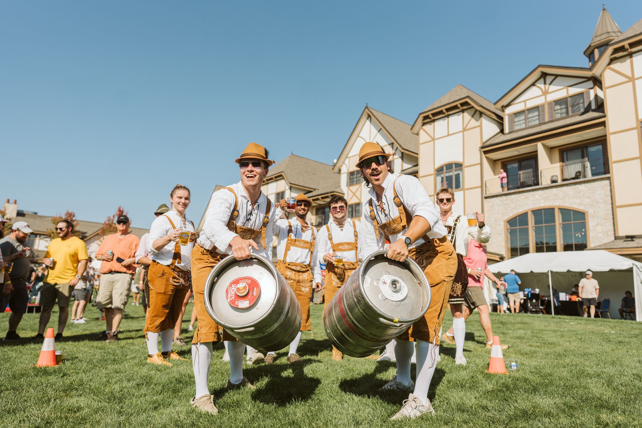 guys wearing lederhosen holding kegs