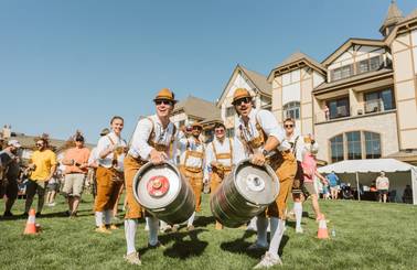 guys wearing lederhosen holding kegs