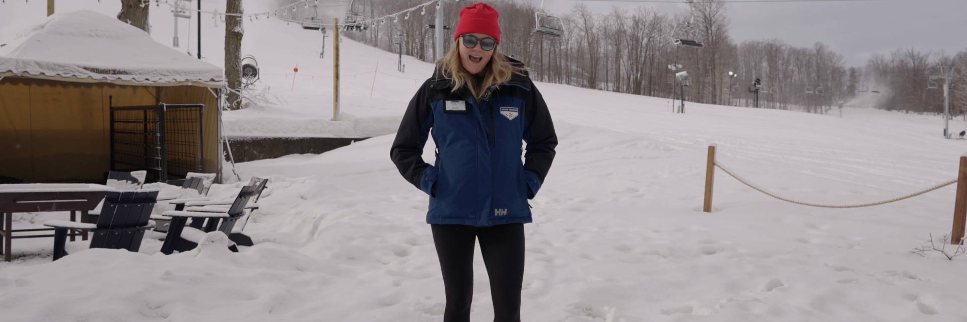 Woman standing in front of ski slope