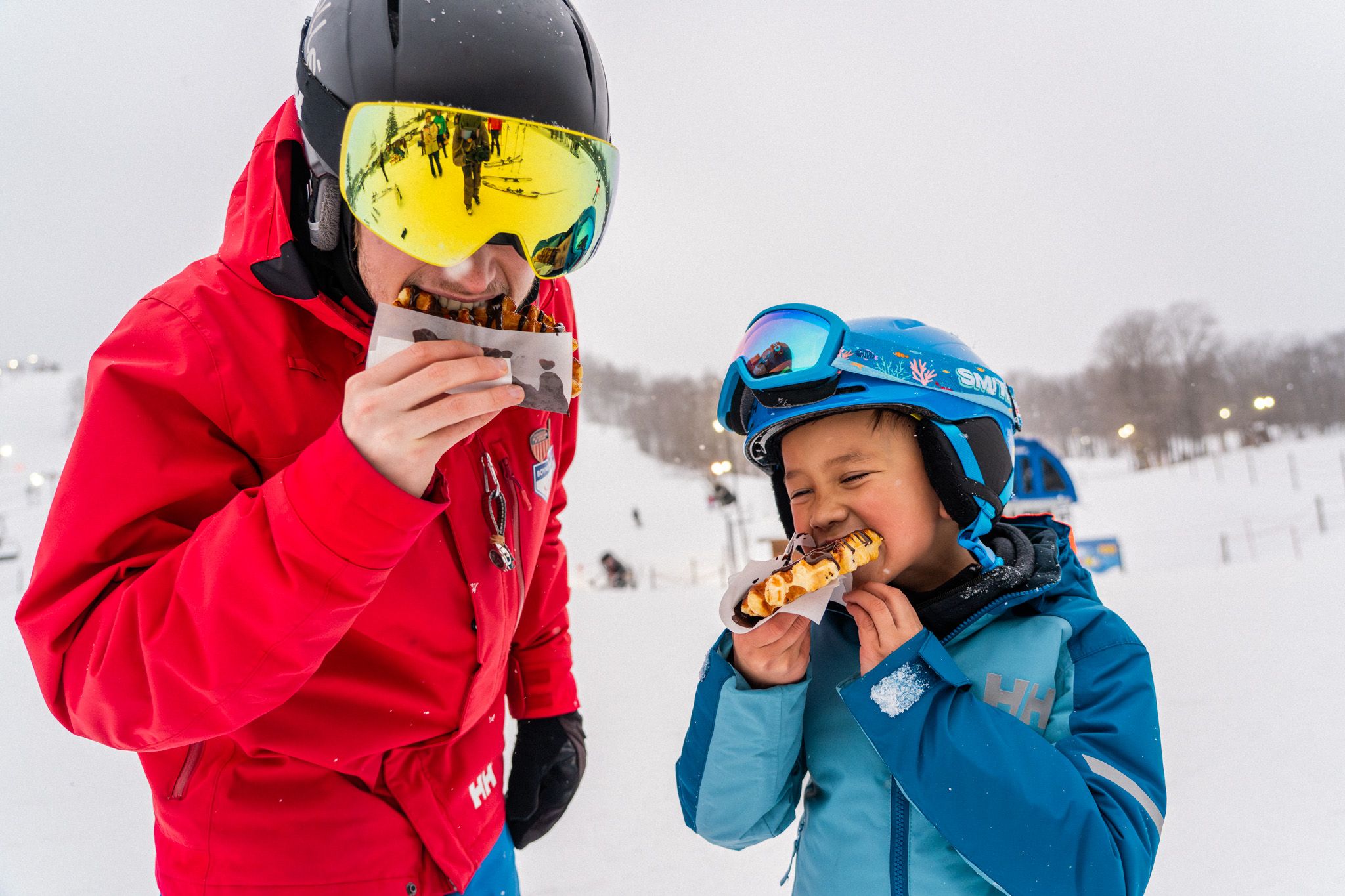 ski instructor eating waffles with student
