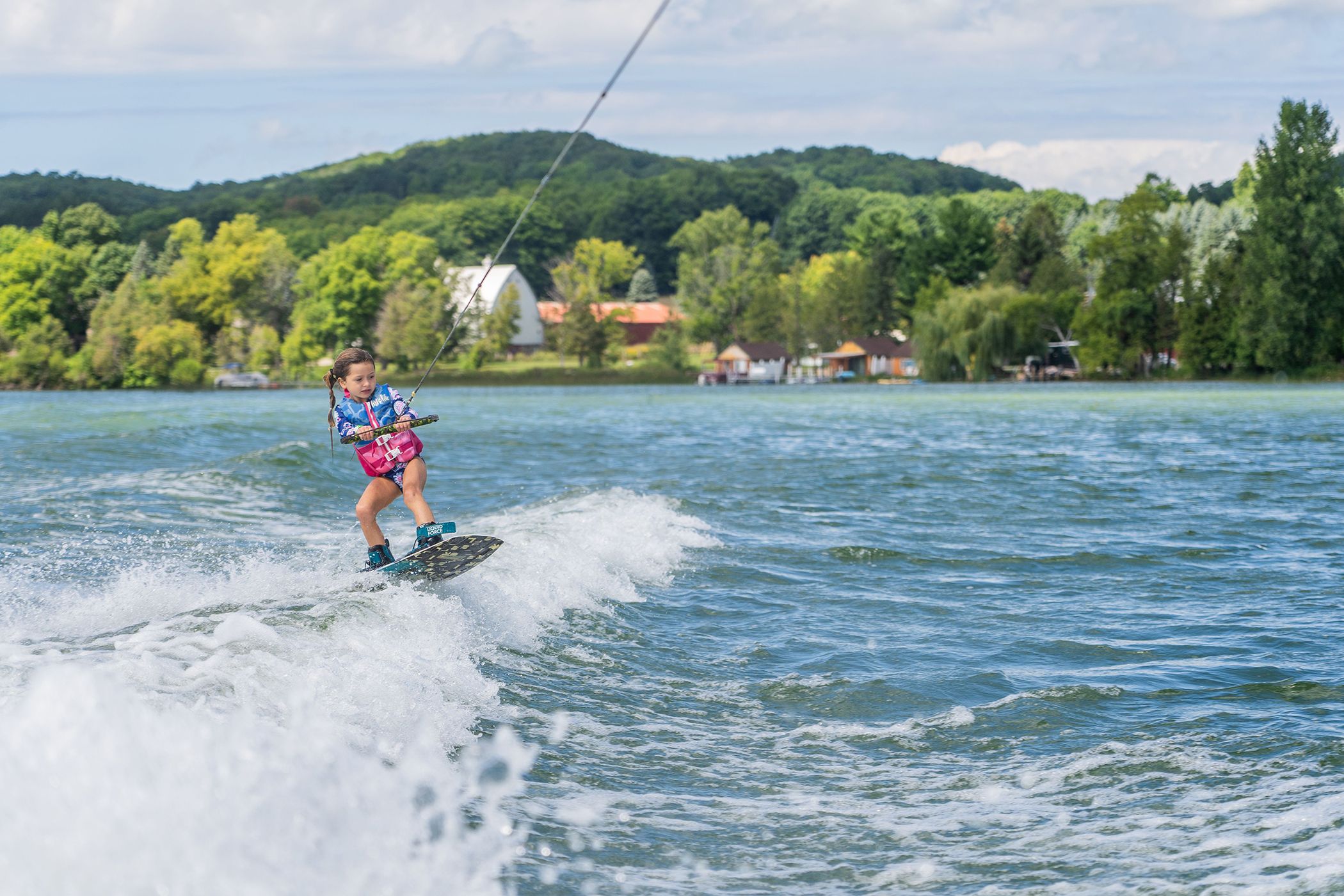 Girl wakeboarding on Deer Lake