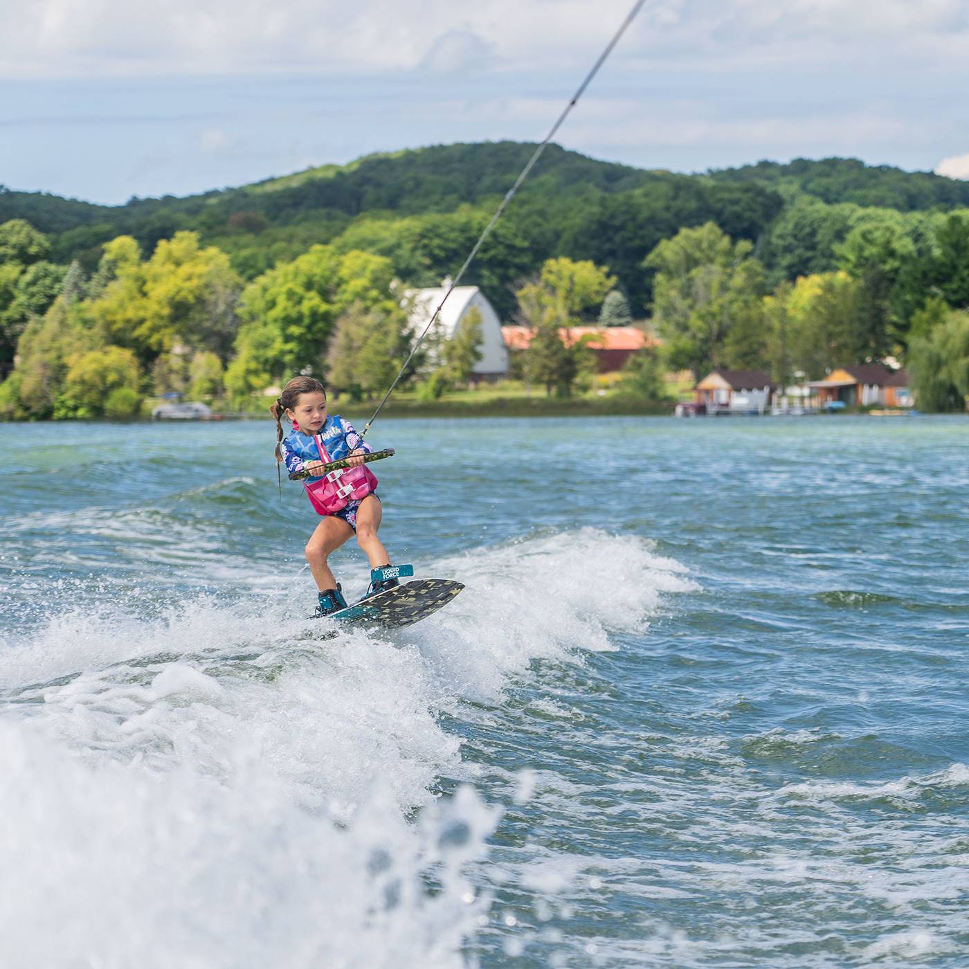 Girl wakeboarding on Deer Lake