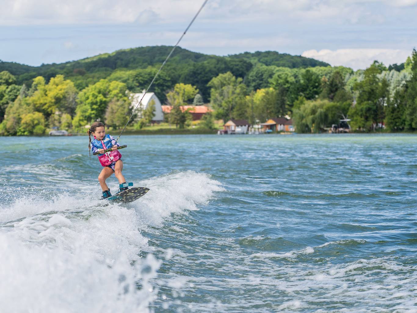 Girl wakeboarding on Deer Lake