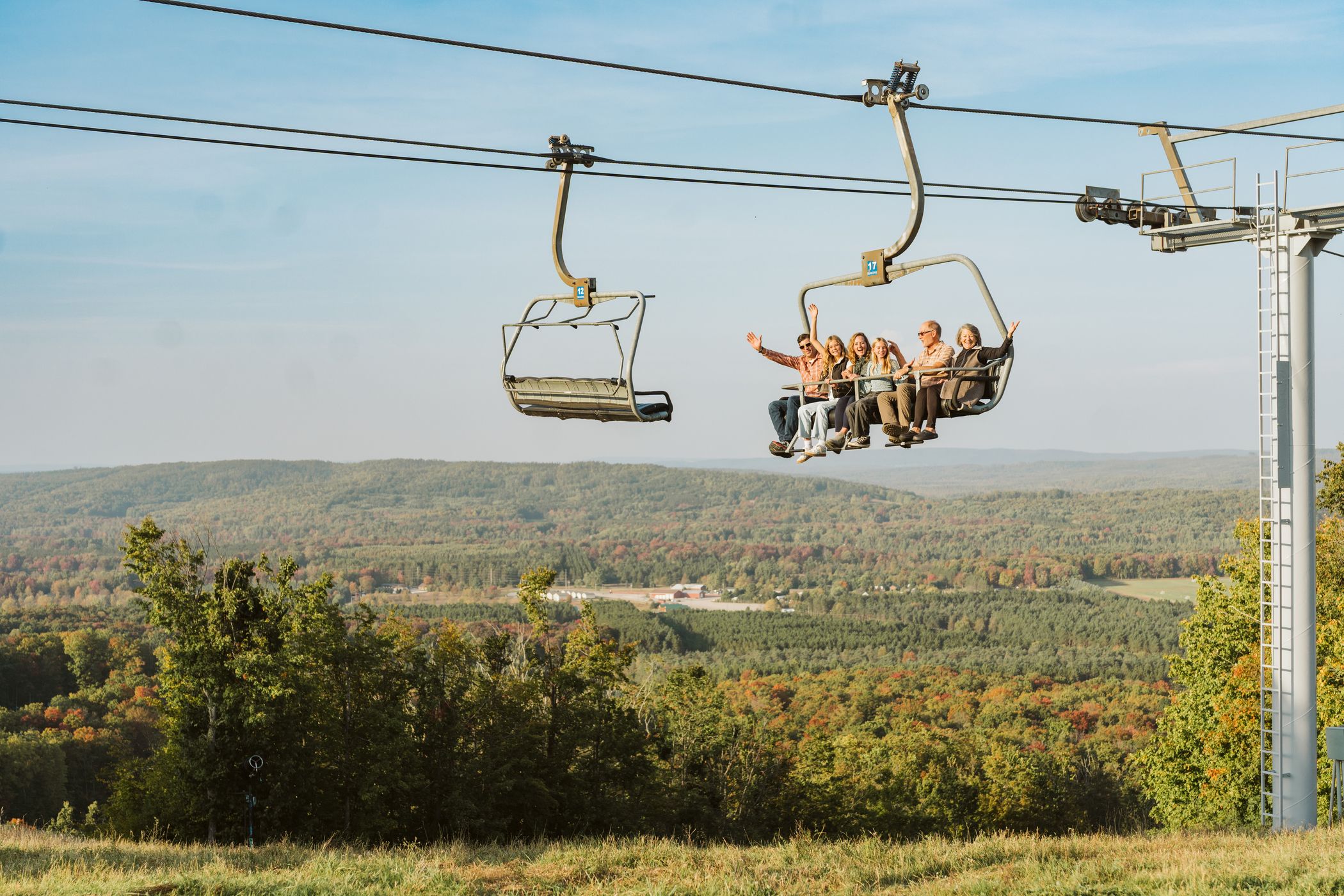 family riding scenic chairlift